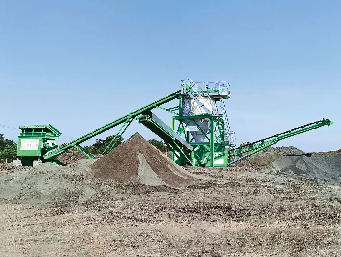 A green CFlo washing plant on a quarry floor, conveyors discharging two stockpiles of washed sand