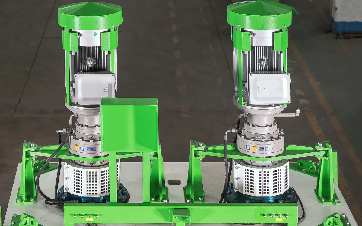 The two drives on top of an Atropure 702, each cell carrying its own vertically mounted motor under a green cowl above its gearbox, with the impeller shaft entering the cell beneath