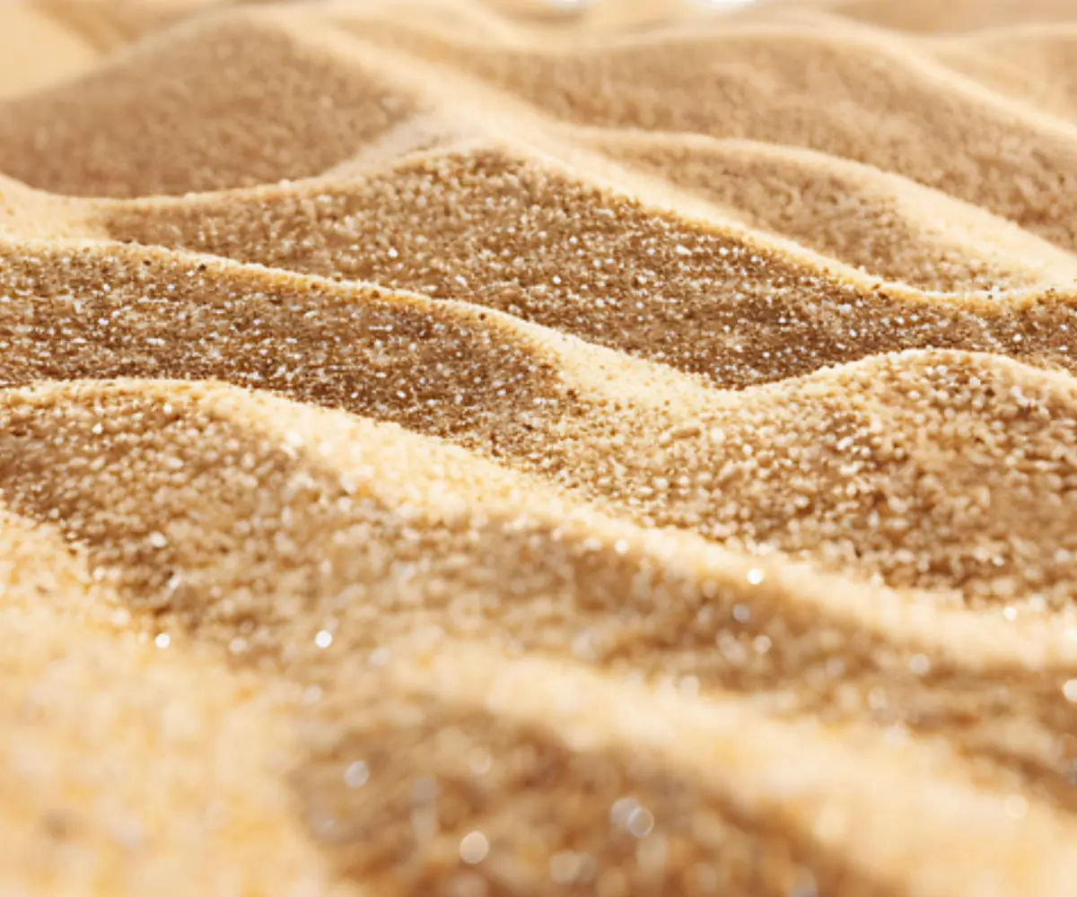 Close-up of golden beach sand grains in fine ridges