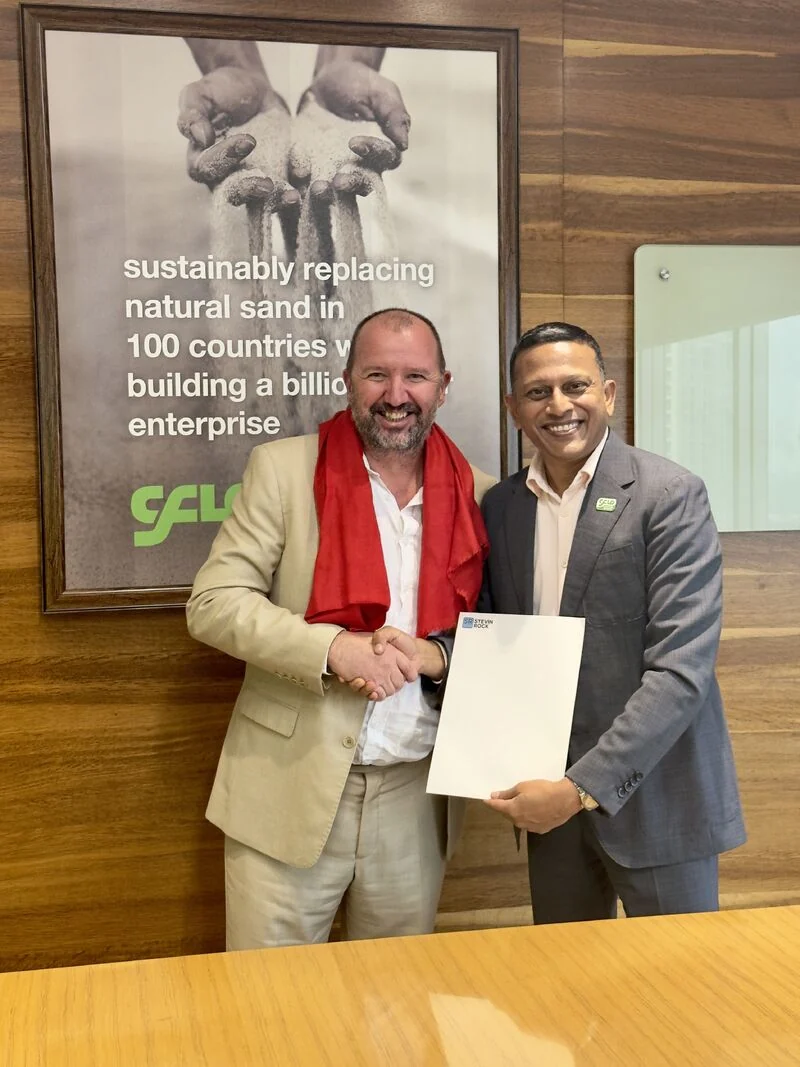 Brian Howard, Operations Director at Stevin Rock LLC, shaking hands with Manish Bhartia, Global CEO and Managing Director of CFlo, after signing the order