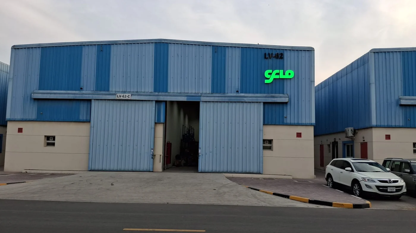 The CFlo World FZE warehouse in the Hamriyah Free Trade Zone, Sharjah, with the CFlo mark above the loading doors