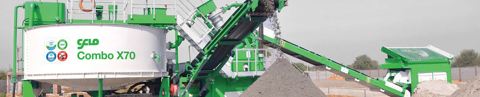 The green CFlo Combo X70 mobile washing plant, feed conveyor raised, on a light background