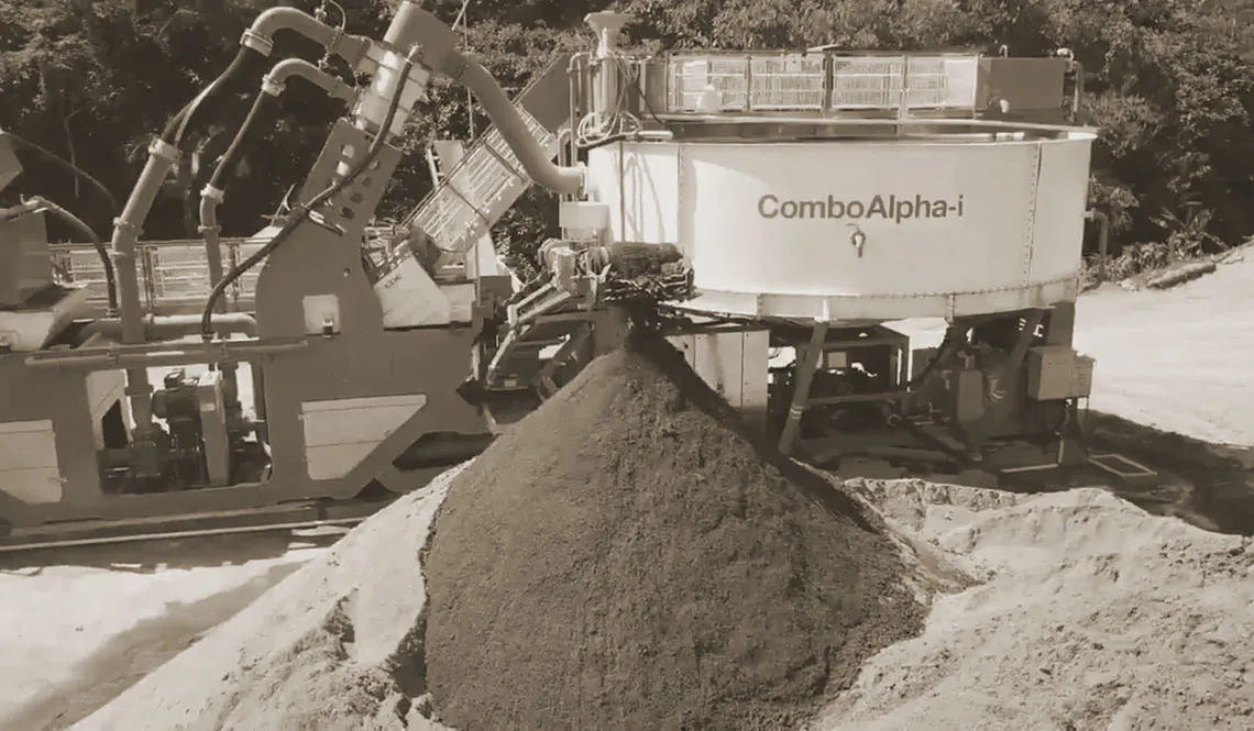 A CFlo ComboAlpha-i unit discharging a cone of damp fine sand