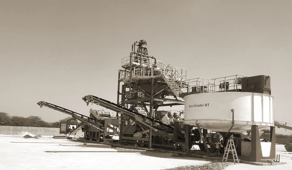 A CFlo Micrograder BT50 with access stairs and conveyors on a prepared pad