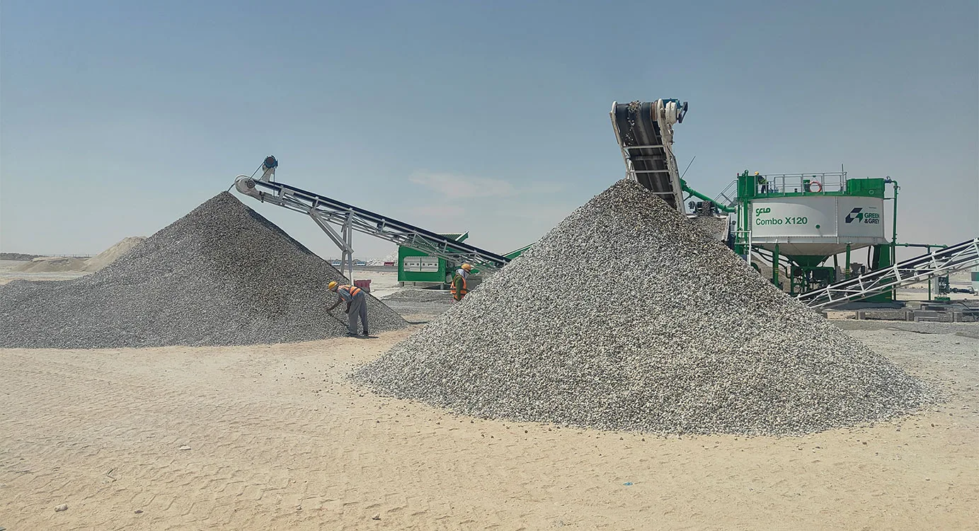 Conveyors discharging two large stockpiles of washed grey aggregate