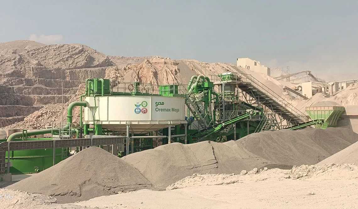 A green CFlo plant beside a quarry face, discharging graded sand stockpiles