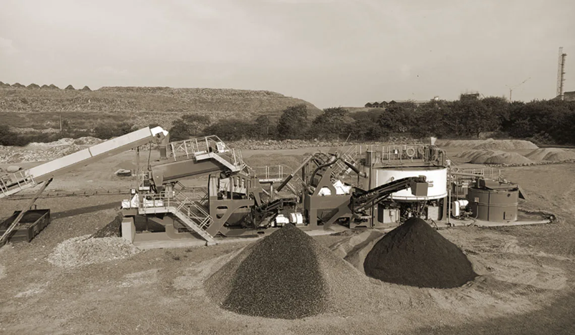 A plant with conveyors discharging two conical stockpiles of contrasting material