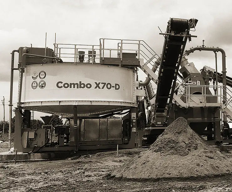 A CFlo Combo X70 on a prepared pad with a conical stockpile of damp sand