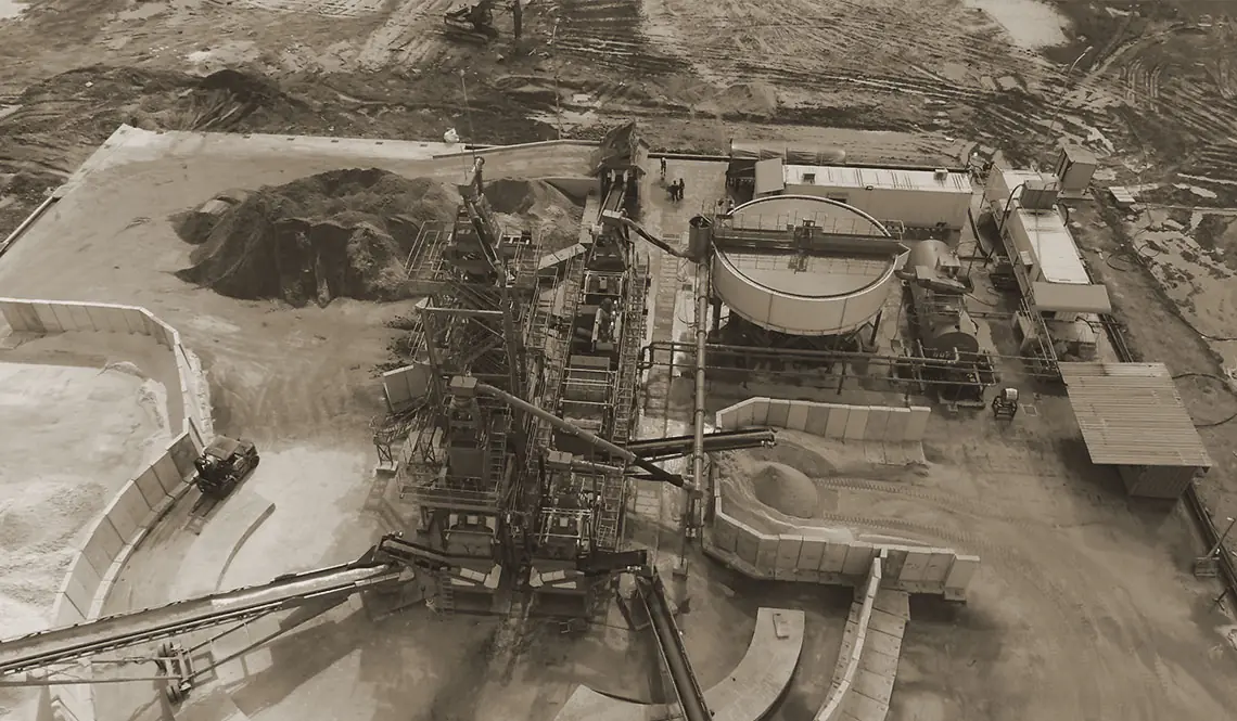 Aerial view of a large plant with a circular thickener among worked ground