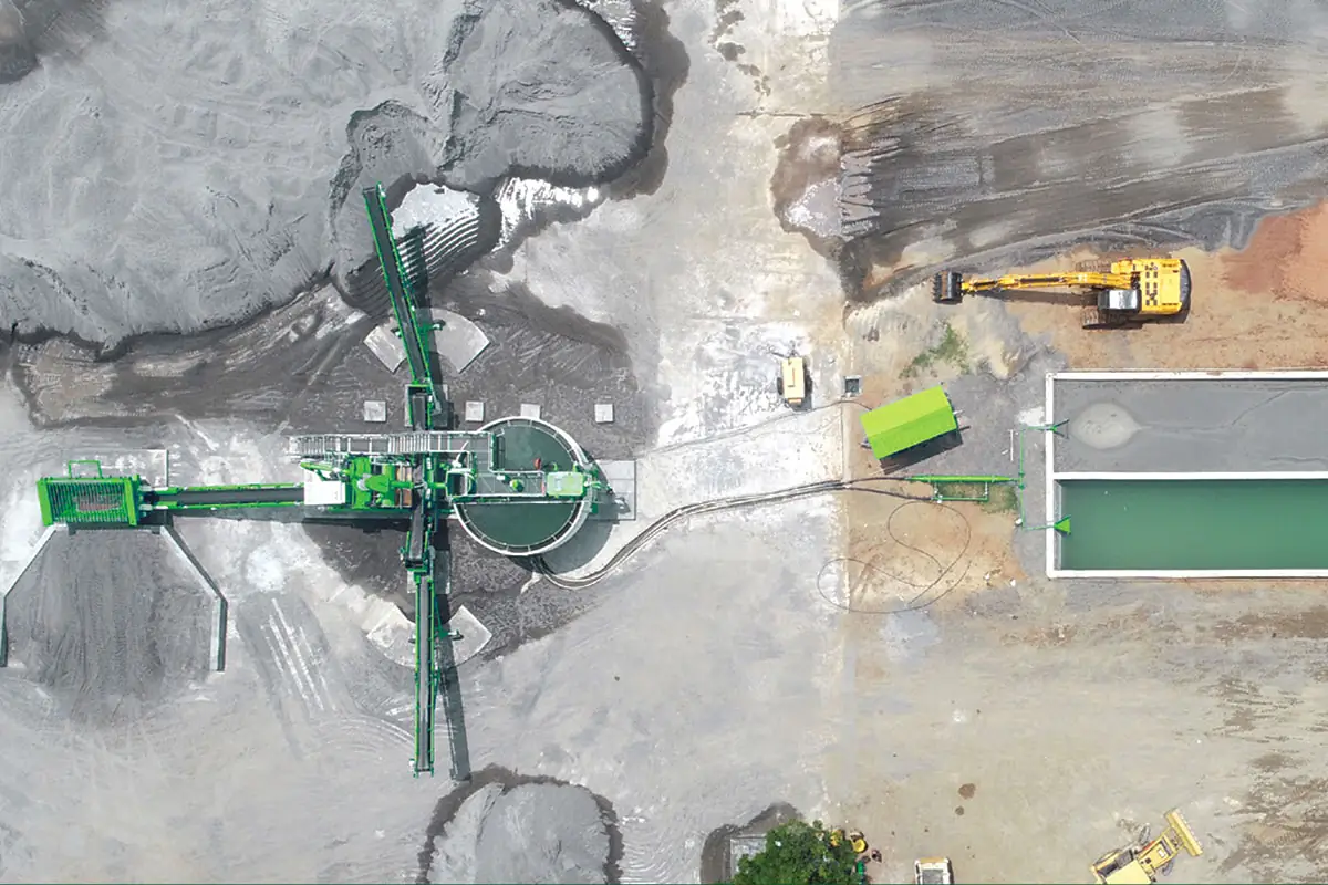 Straight-down aerial view of a CFlo plant, conveyors radiating from a central thickener, with pipework running across to a rectangular bay of clarified green water