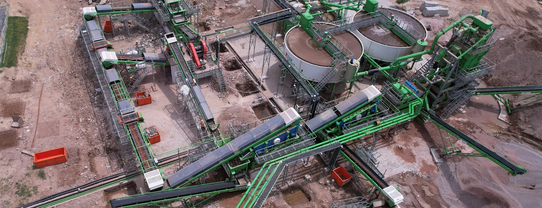 The Reurban circuit at India's largest C&D waste recycling plant, Burari in Delhi: feed conveyors, screens and the twin thickeners that recover the process water